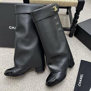 Chanel black leather fold-over boots with a cap toe and button details 